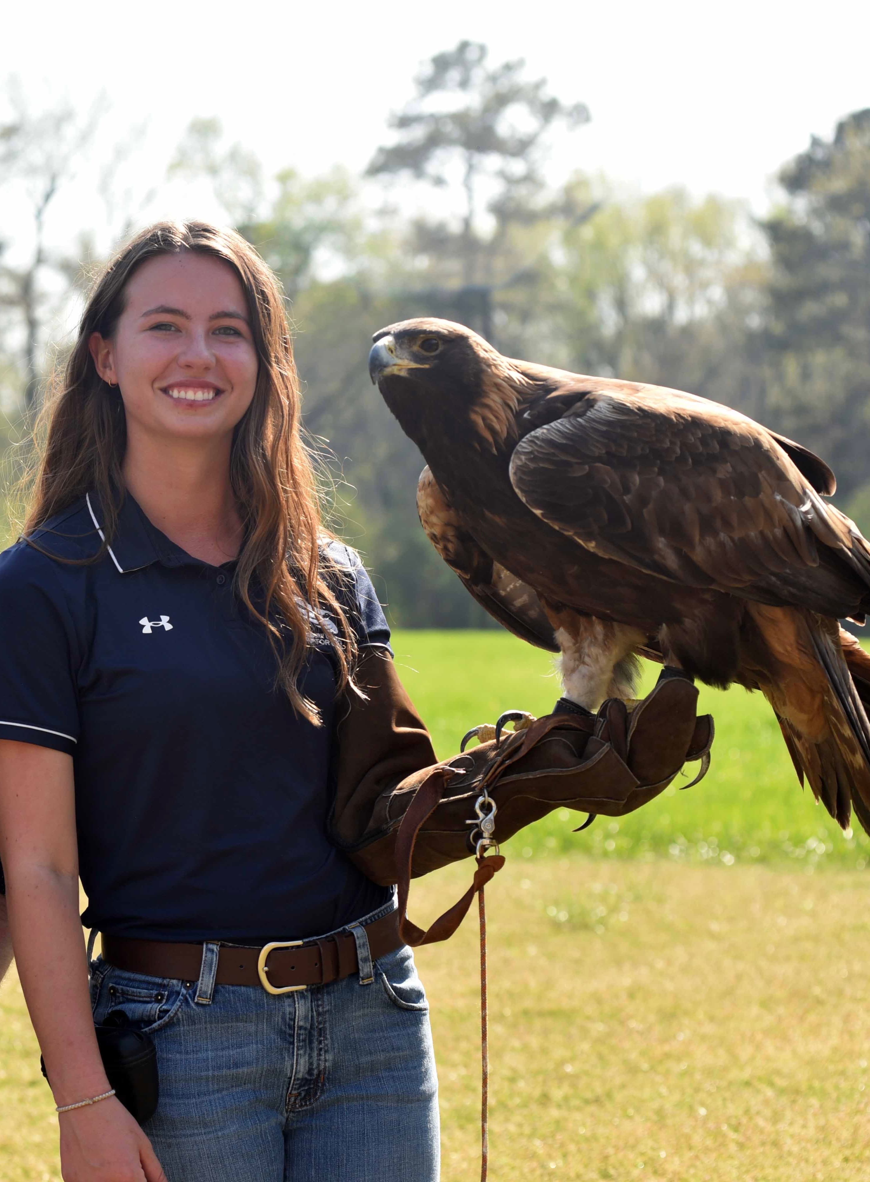 Katelynn with golden eagle in field